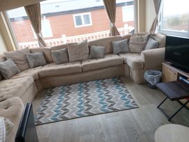 A snug with a sofa and rug at Golden Sands FSB38 in Rhyl