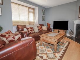 A living room with a sofa and coffee table at 1 Grenville Road in Truro
