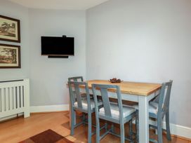 A dining room with a table and chairs at 1 Grenville Road in Truro