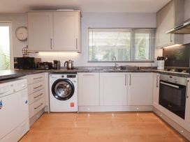 A kitchen with appliances and cabinets at 1 Grenville Road in Truro