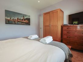 A bedroom with a bed and wardrobe at 1 Grenville Road, Truro