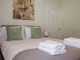A bedroom with a bed and towels at 1 Grenville Road in Truro