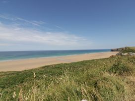 A beach with ocean view and grass in the foreground at 1 Grenville Road, Truro
