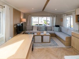 A living room with a sofa and coffee table at 5 Rowen Court in Scarborough