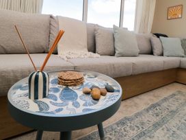 A living room with a sofa and table at 5 Rowen Court in Scarborough
