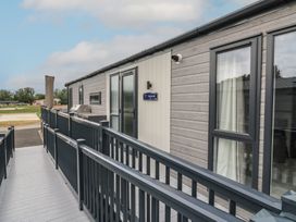 An outdoor area with a building and pathway at Lodge 1 St. Osyth