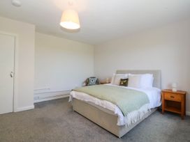 A bedroom with a bed and nightstand at Wilpol in Llanerchymedd