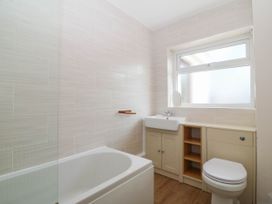 A bathroom with a bathtub, toilet, and sink at Wilpol in Llanerchymedd