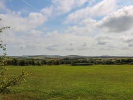 A landscape view of a field with hills in the background at Wilpol in Llanerchymedd