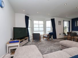 A living room with a television and seating area at The Gulls Rest