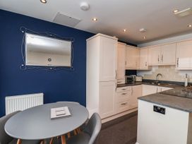 A kitchen with a table and chairs at The Gulls Rest in 