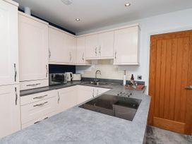 A kitchen with cabinets and appliances at The Gulls Rest 