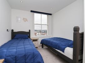 A bedroom with two beds and a window at The Gulls Rest in 