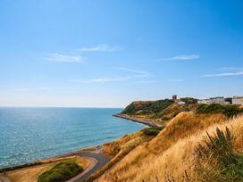 A view of the sea and cliffs with a road at The Gulls Rest 