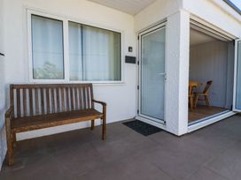 An outdoor area with a bench and a door leading to an interior at 9 Tides Reach Wadebridge