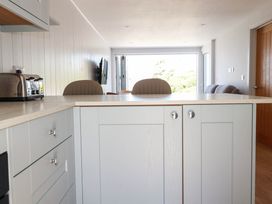 A kitchen featuring a toaster and stools at 9 Tides Reach in Wadebridge