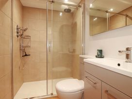 A bathroom with a shower, toilet, and sink at 9 Tides Reach Wadebridge