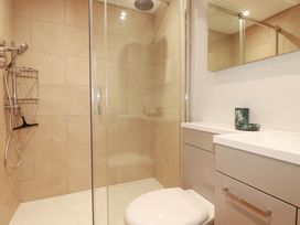 A bathroom with a shower, toilet, and sink at 9 Tides Reach in Wadebridge