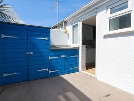 An outdoor area with blue storage units and a doorway at 9 Tides Reach Wadebridge