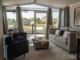 A living room with a sofa and armchairs at Lakewood Plot 5 St. Osyth