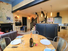 A dining room with a table set for a meal at The Sunday School Room in Sherborne