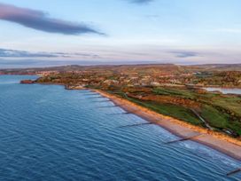A coastal view showing a beach and hills at Golden Sands Holiday Park, Dawlish