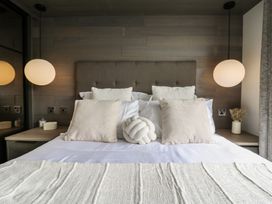 A bedroom with a bed and pillows at Lodge 2 in St. Osyth