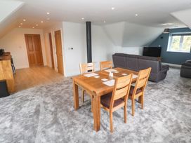 A living room with a dining table and sofa at 6 Coswinsawsin Lane near Camborne