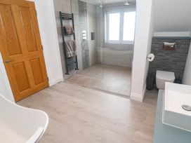 A bathroom with a shower, sink, and toilet at 6 Coswinsawsin Lane near Camborne