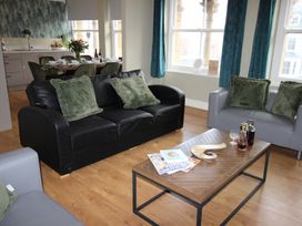 A living room with a coffee table and sofa at Cornerhouse Apartment 1 in Llandudno