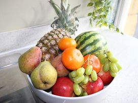 A bowl of assorted fruits including pineapple and watermelon at Cornerhouse Apartment 1 Llandudno