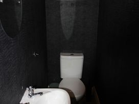 A bathroom with a toilet and sink at Cornerhouse Apartment 1 in Llandudno