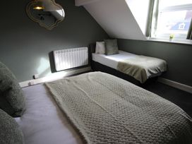 A bedroom with a double and single bed at Cornerhouse Apartment 1 in Llandudno