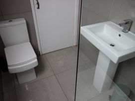 A bathroom with a toilet and a sink at Cornerhouse Apartment 4 Llandudno
