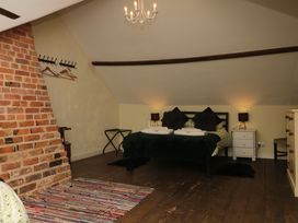 A bedroom with a bed and nightstands at The Cheese House near Charmouth
