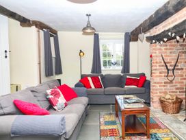 A living room with sofas and a table at The Cheese House near Charmouth