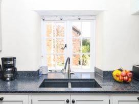 A kitchen with sink, coffee maker, and fruit bowl at The Cheese House near Charmouth