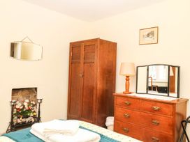 A bedroom with a wardrobe and dressing table at The Cheese House near Charmouth