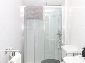 A bathroom with a shower, toilet, and sink at The Cheese House near Charmouth
