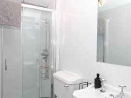 A bathroom with a shower, sink and toilet at The Cheese House near Charmouth