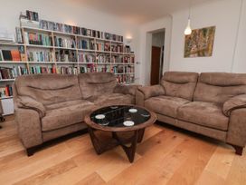 A living room with a sofa and coffee table at 26 Metropole Towers in Whitby