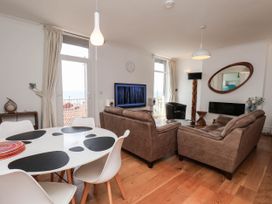 A living room with a sofa and dining table at 26 Metropole Towers in Whitby