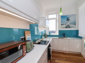 A kitchen with appliances and a window at 26 Metropole Towers in Whitby
