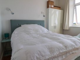 A bedroom with a bed and wardrobe at 26 Metropole Towers in Whitby