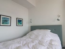 A bedroom with a bed and wall art at 26 Metropole Towers in Whitby