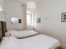 A bedroom with twin beds and a window at 26 Metropole Towers in Whitby