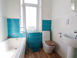 A bathroom with a bathtub, toilet, and sink at 26 Metropole Towers in Whitby