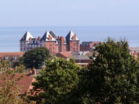 A view of buildings and trees with the sea in the background at 26 Metropole Towers Whitby