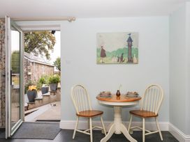A dining room with a table and chairs at Little Moorgate in Okehampton