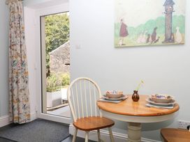 A dining room with a table and chairs at Little Moorgate in Okehampton